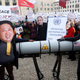 An activist with a mask of Kim Jong Un, chairman of the Workers’ Party of Korea and supreme leader of North Korea, and another with a mask of President Donald Trump march with a model of a nuclear rocket during a demonstration against nuclear weapons on Nov. 18, 2017, in Berlin.